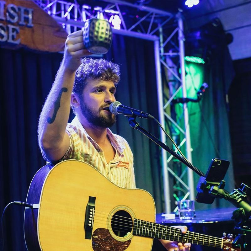 Alex Napier playing guitar live