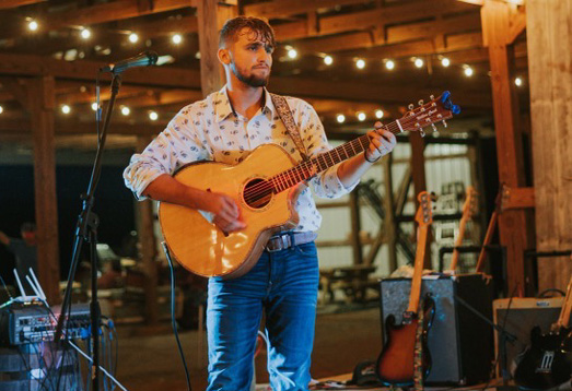 Alex Napier Playing Guitar